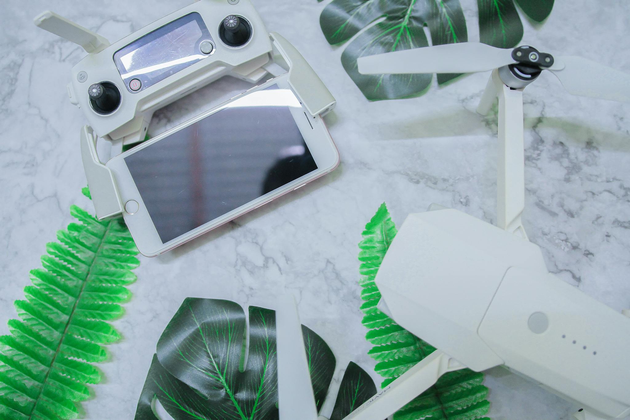 Drone on white table with plant